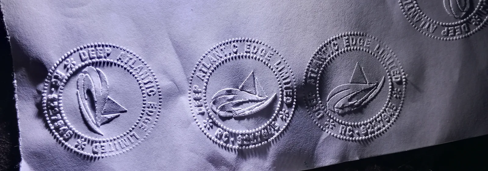 A completed embossing seal impression showing the raised, tamper-evident texture produced by MALLAMIBRO's embossing seals